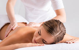masseur massaging pleased young woman on massage table in spa salon, banner